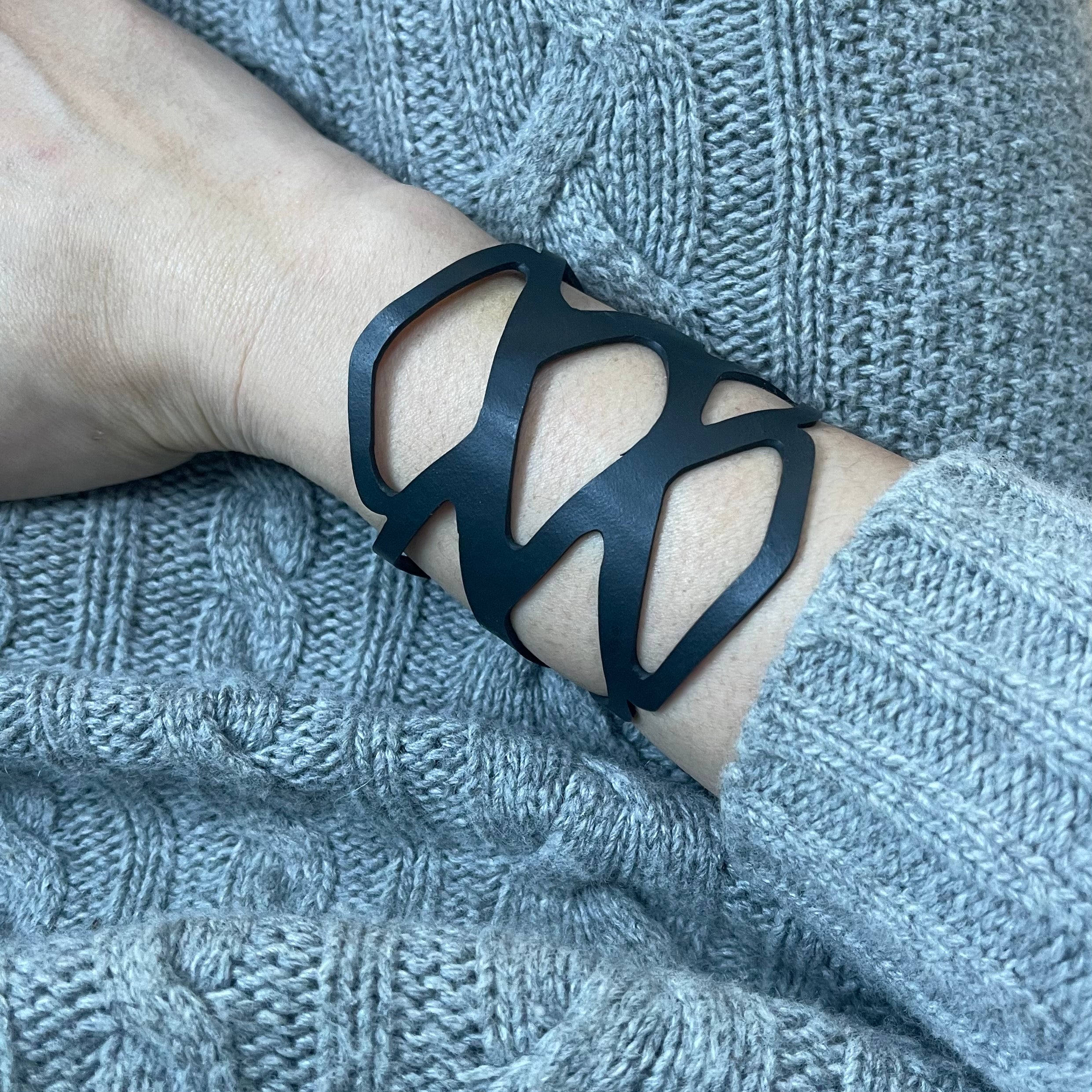 Paguro Upcycle black recycled rubber bracelet with abstract cutout design worn on wrist
