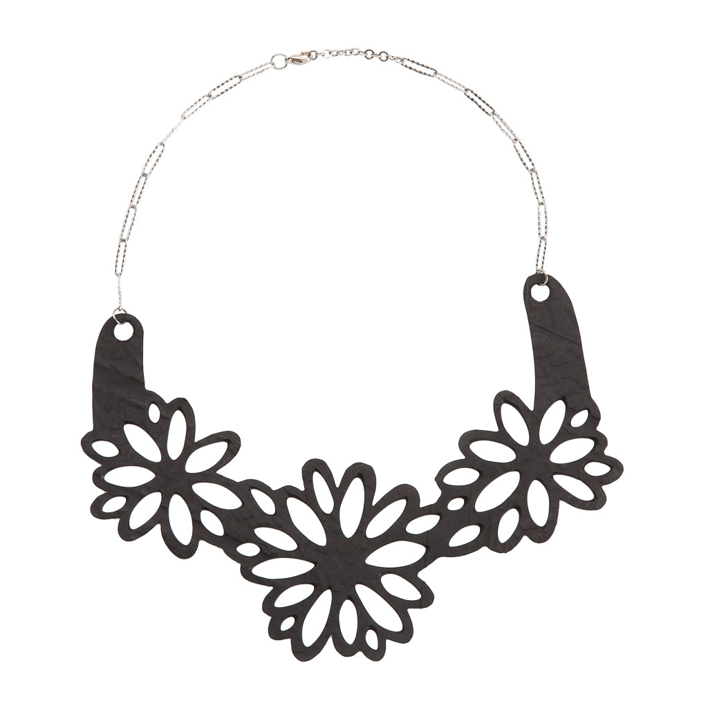 Paguro Upcycle upcycled inner tube necklace with black floral cutout design and silver chain