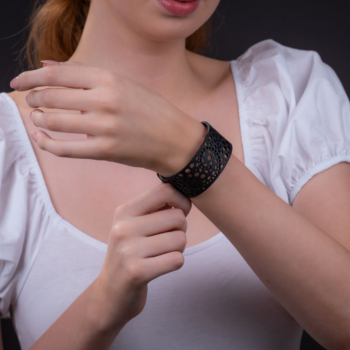 Paguro Upcycle recycled rubber bracelet in black with intricate cut-out design worn on wrist