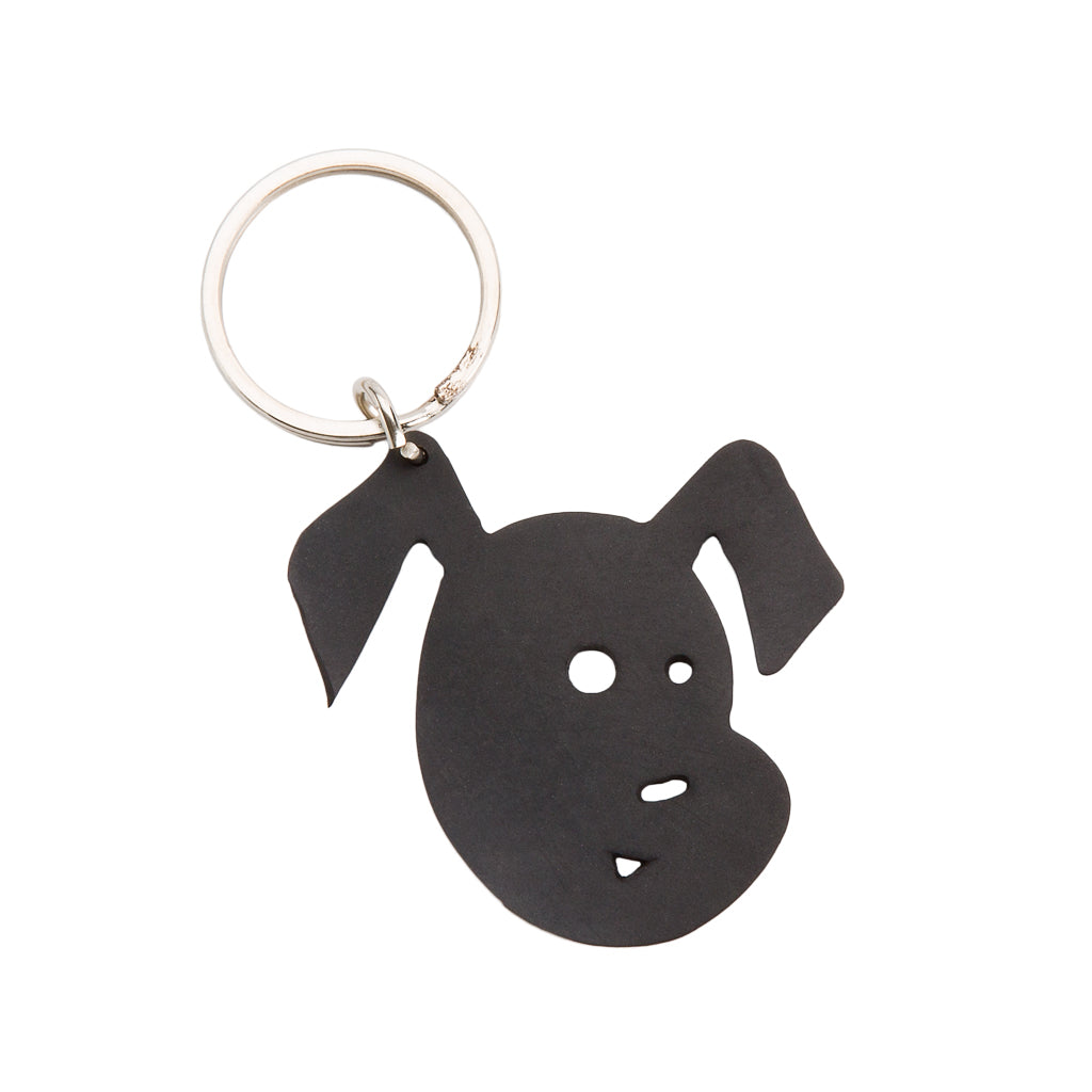 Paguro Upcycle recycled rubber dog keyring shaped like a black dog face with cutout eyes and nose