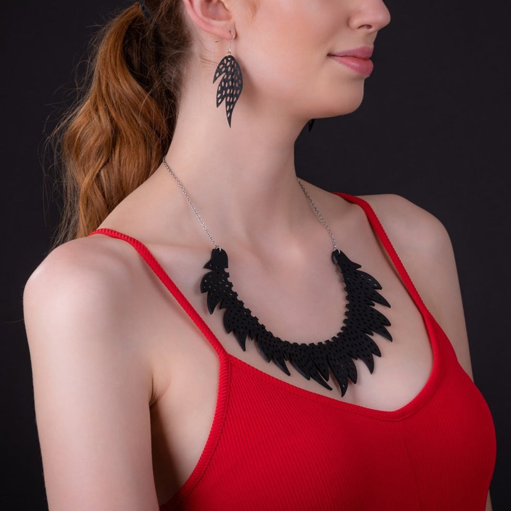 Paguro Upcycle black upcycled inner tube necklace with leaf design worn with matching earrings