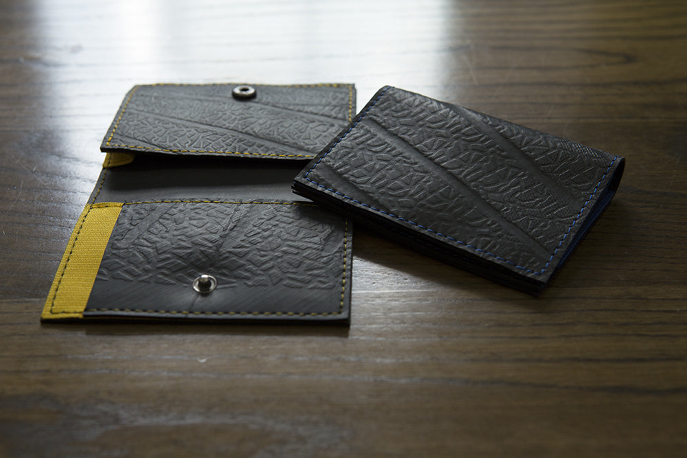 Vegan recycled rubber slim card holder in black with yellow accents and snap closure design