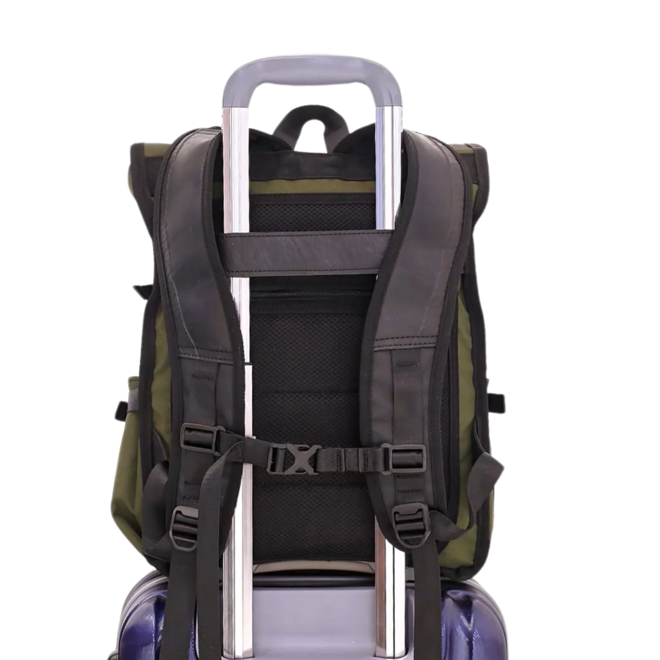 Backpack strapped onto the handle of a rolling suitcase.