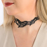 Paguro Upcycle black recycled rubber choker necklace with leaf pattern worn by a woman