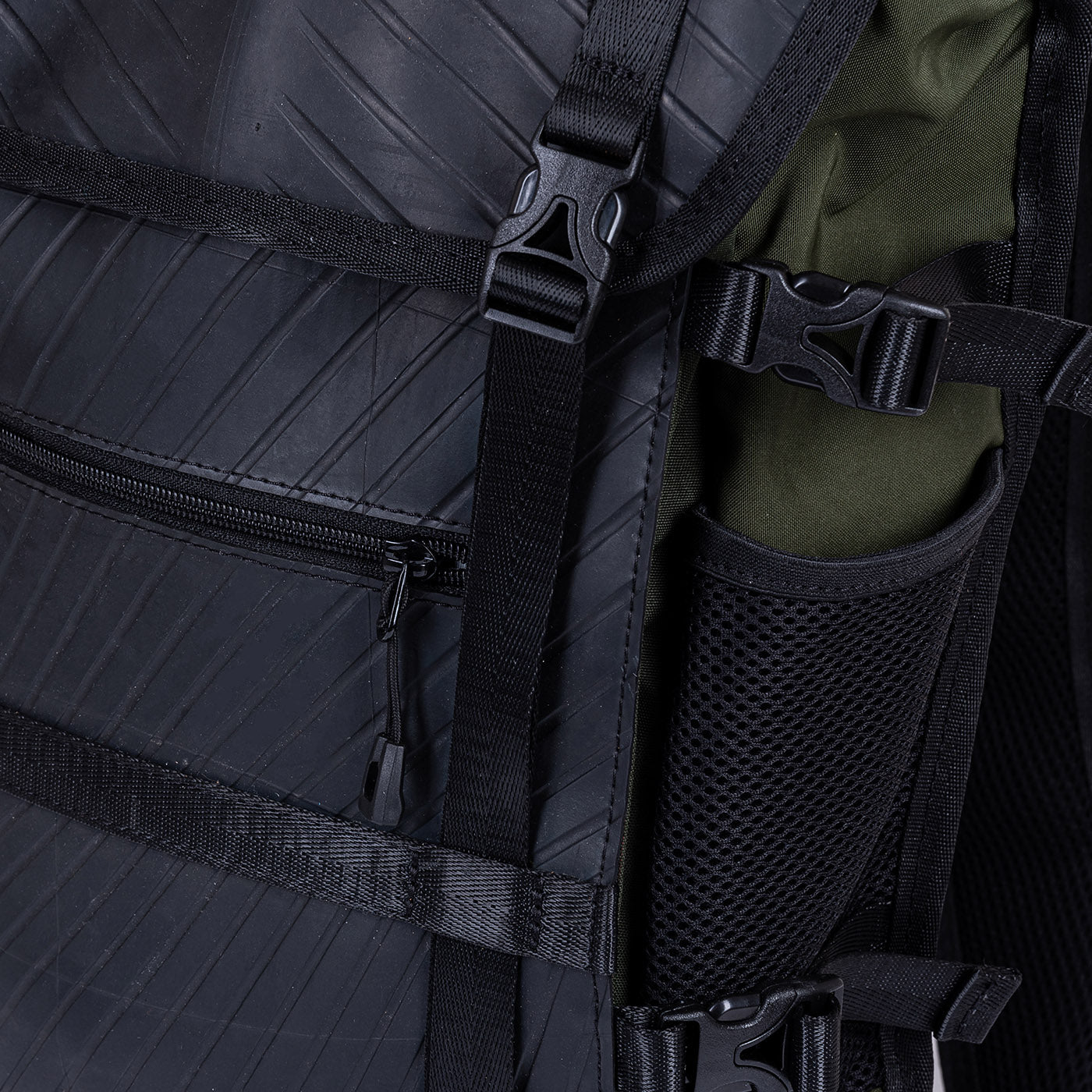 Close-up of backpack straps, zipper, and side pocket.