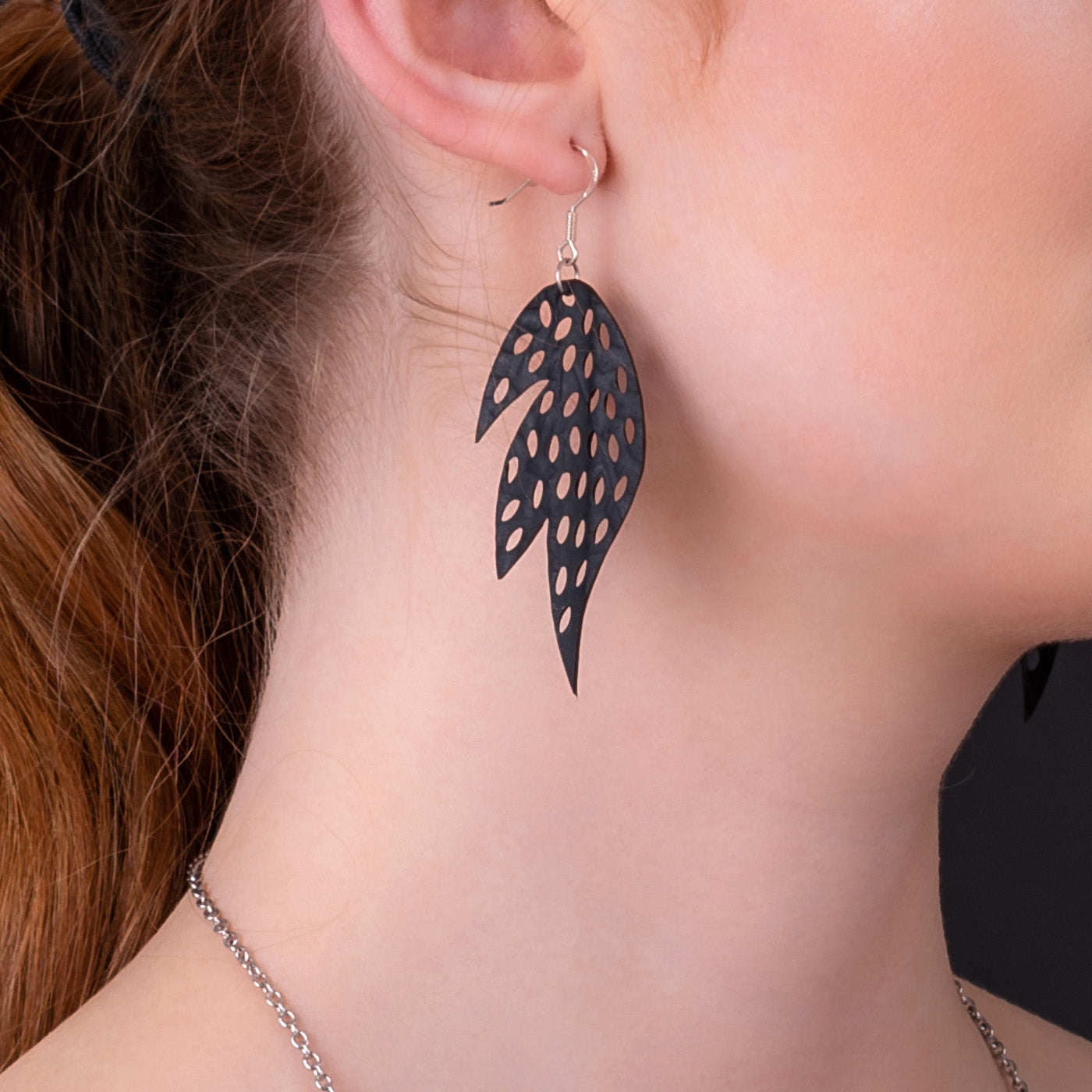 Paguro Upcycle recycled rubber earrings black leaf shape with oval cutouts on silver hook