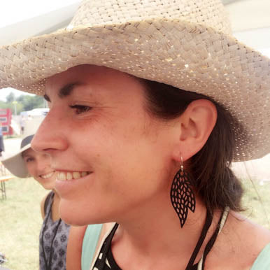 Paguro Upcycle model wearing black leaf cutout recycled rubber earrings on silver hooks