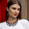 Paguro Upcycle geometric recycled necklace with black angular shapes worn by woman