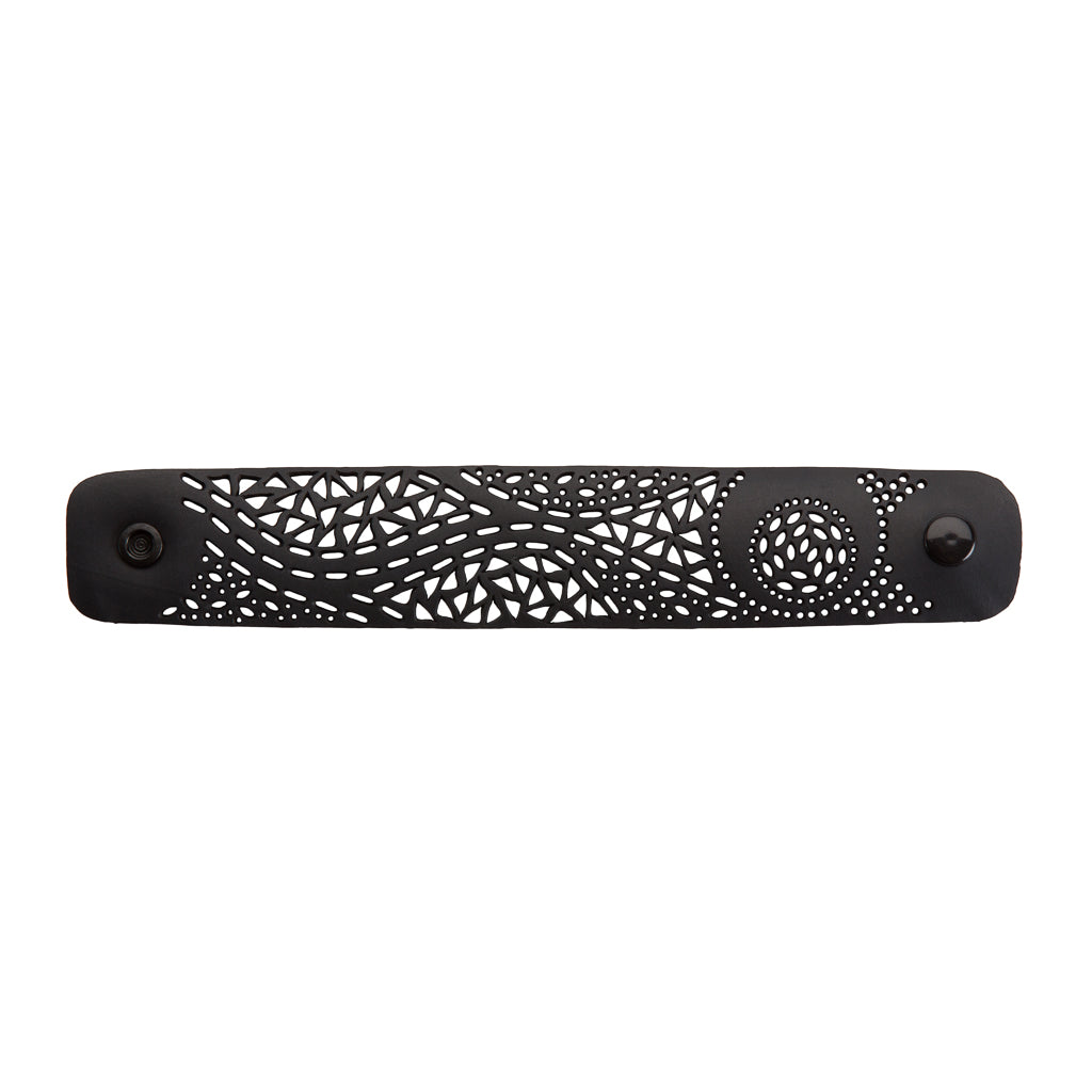 Paguro Upcycle black recycled rubber bracelet with intricate geometric cutout design and snap closure