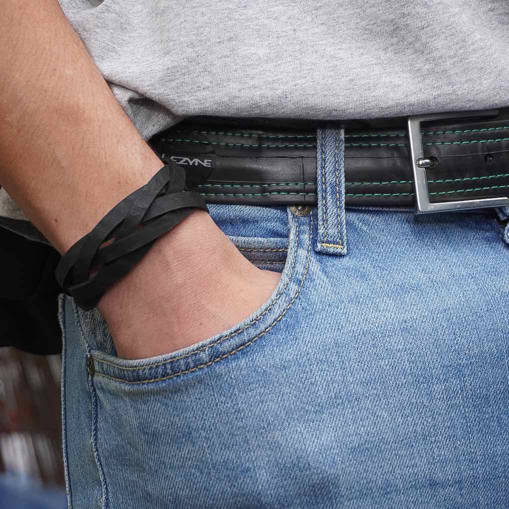 Paguro Upcycle braided black recycled rubber bracelet UK worn as double wrap on wrist with casual jeans outfit