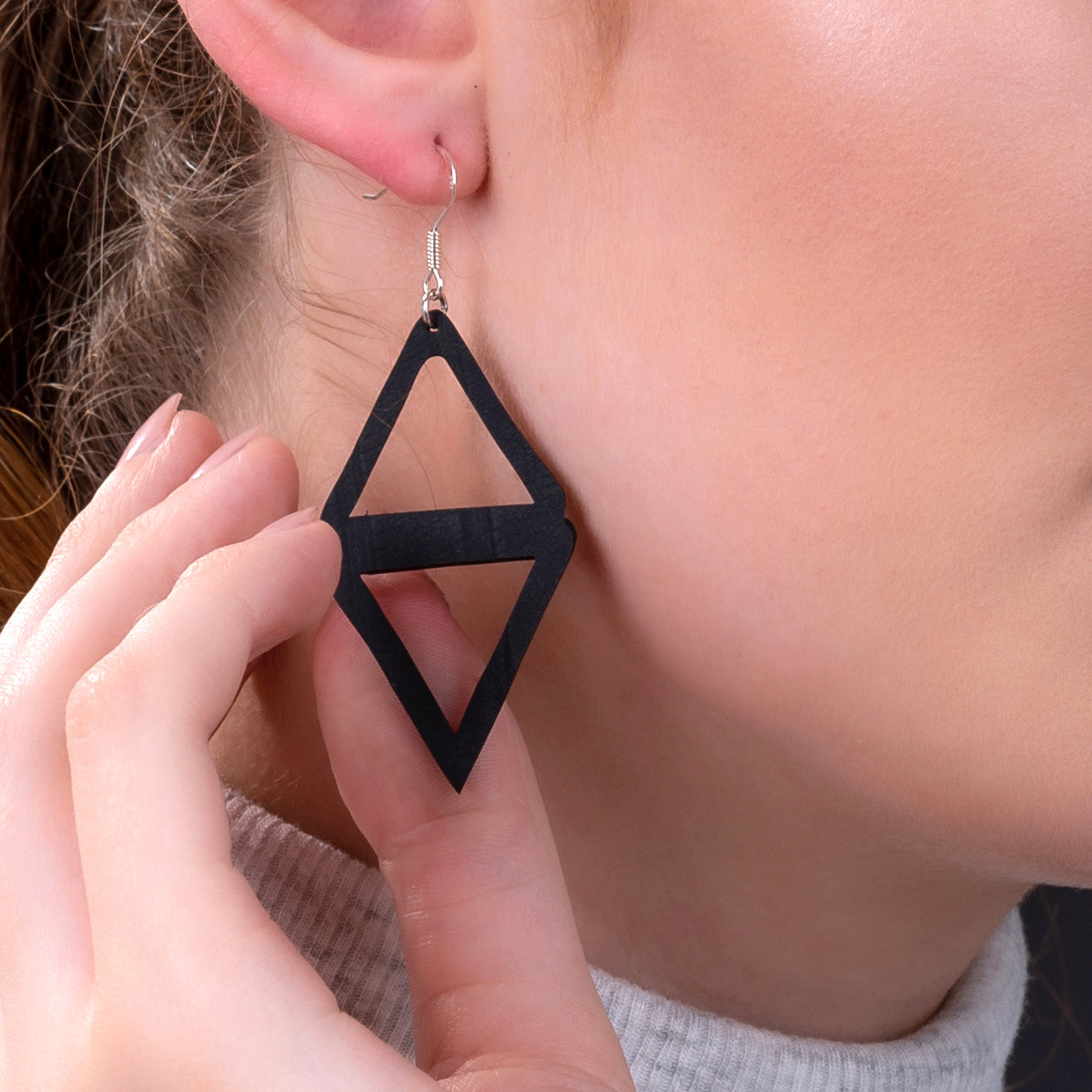 Paguro Upcycle black geometric diamond dangle recycled rubber earrings shown worn on ear