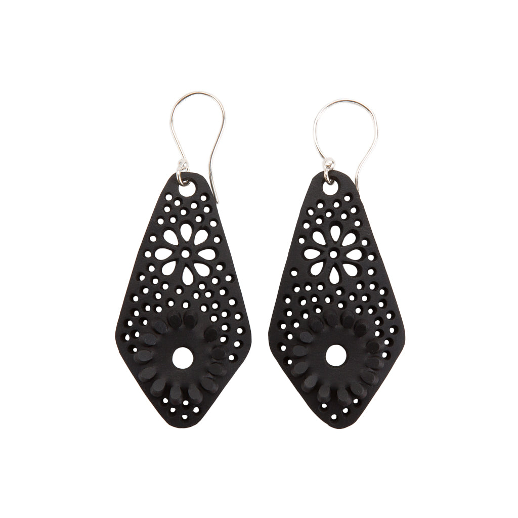 Paguro Upcycle black recycled rubber earrings with floral cutout design and silver hooks