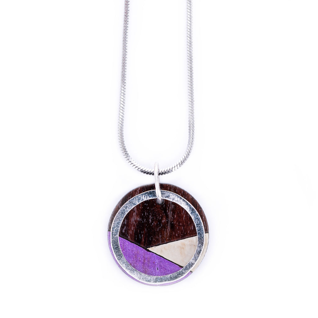 Paguro Upcycle recycled wood silver necklace with circular pendant featuring purple and natural wood inlays