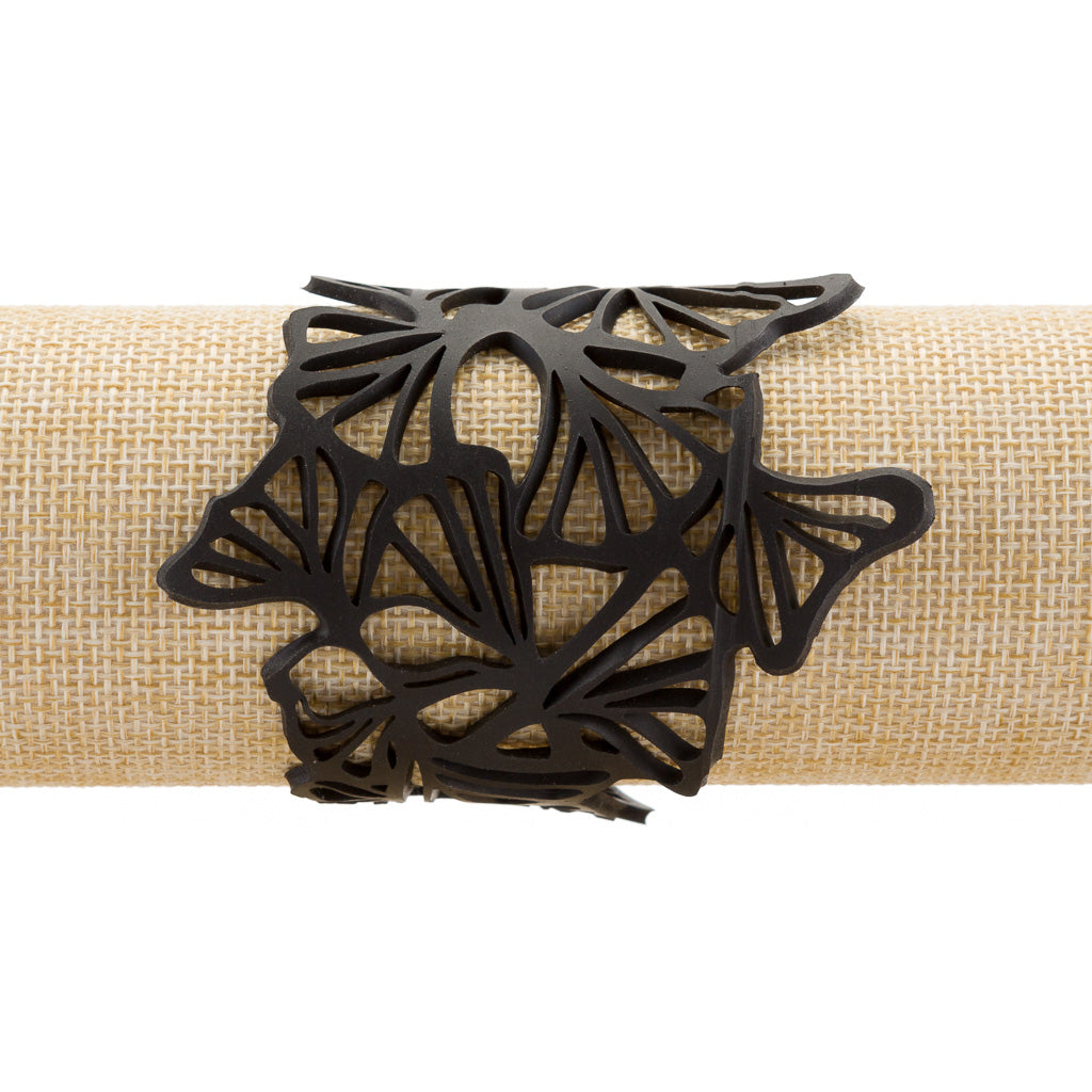 Paguro Upcycle black upcycled rubber bracelet with intricate cutout leaf design on burlap display