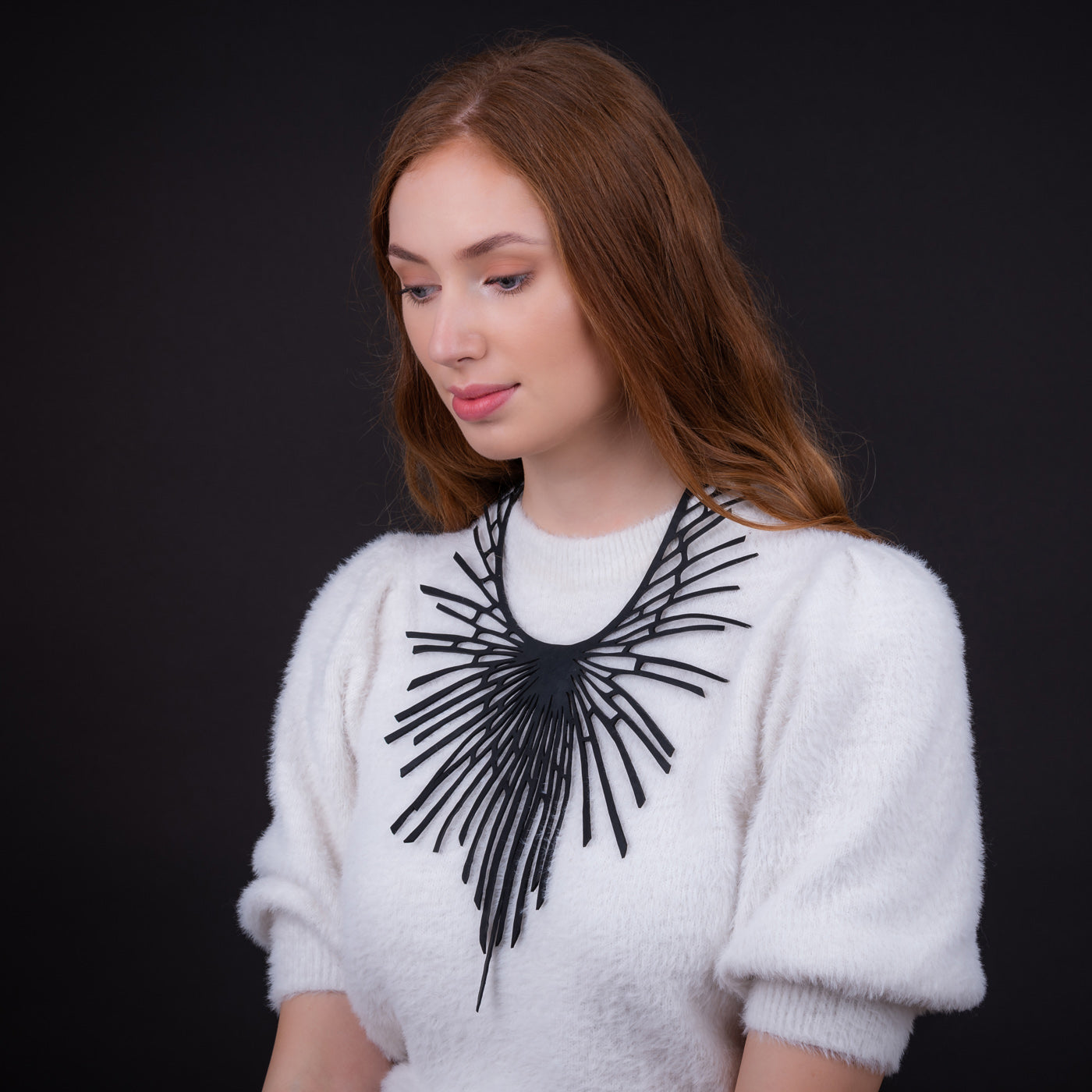 Paguro Upcycle black upcycled statement necklace with bold modern design worn with white sweater