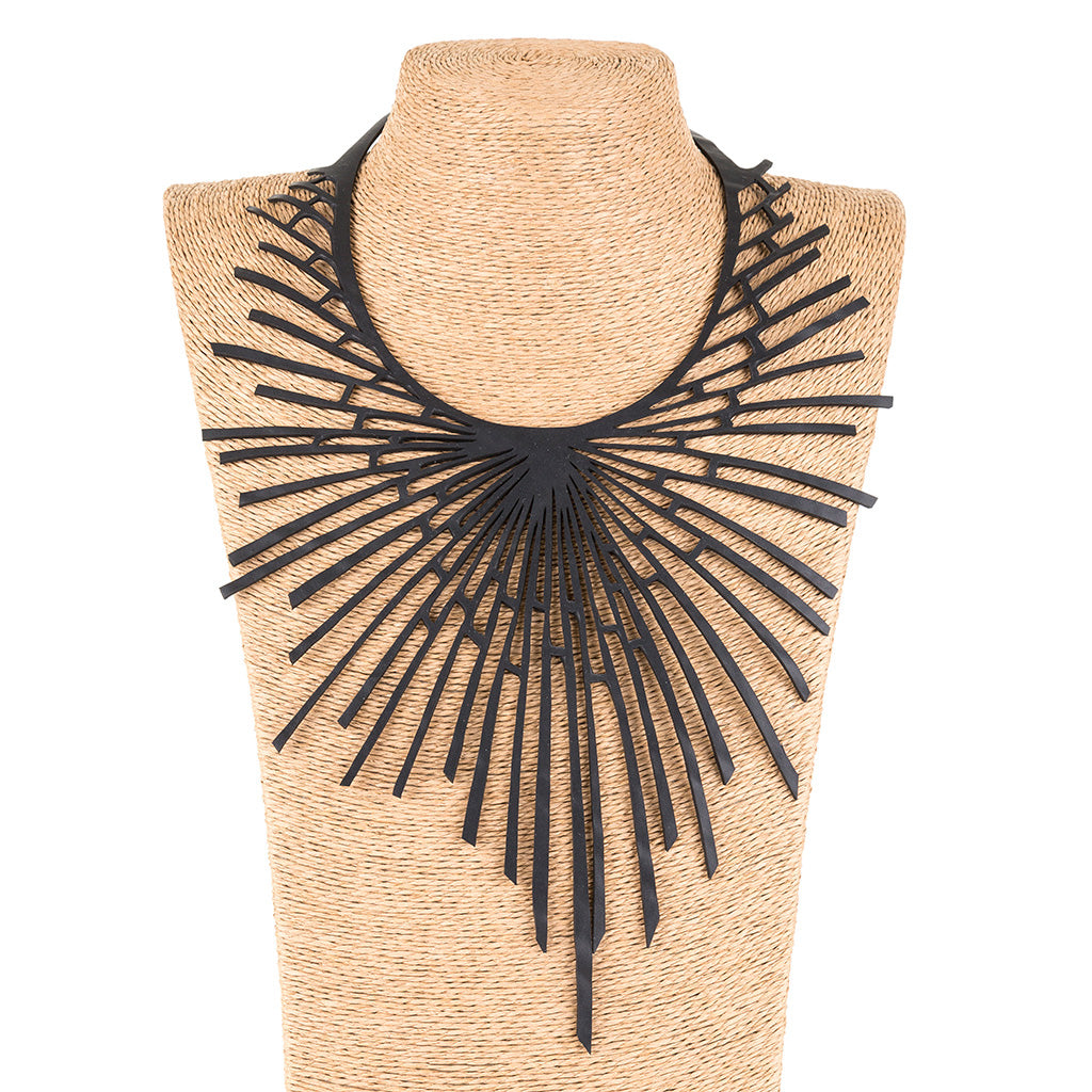 Paguro Upcycle black unique design upcycled statement necklace displayed on a woven bust