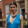 Paguro Upcycle layered black recycled necklace worn by model in blue dress vegan statement necklace for women