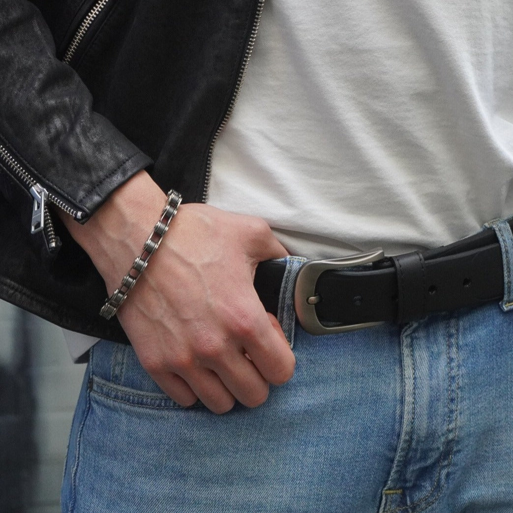 Paguro Upcycle black recycled rubber belt worn with blue jeans and white shirt