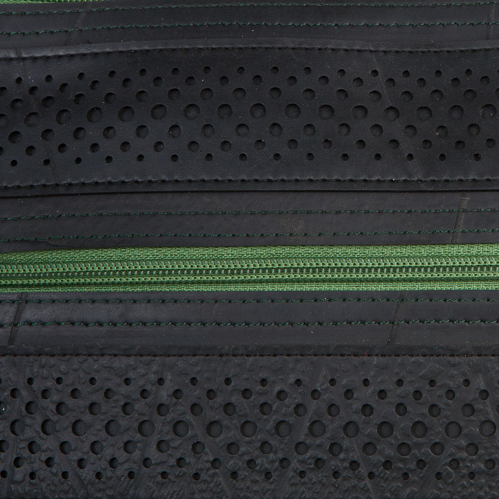 Close-up of black recycled rubber vegan handbag with green zipper by Paguro Upcycle