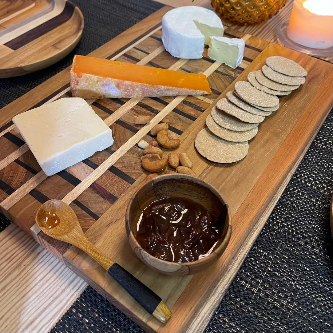 Paguro Upcycle upcycled wooden mini bowl filled with jam on a wooden serving board with cheese and crackers