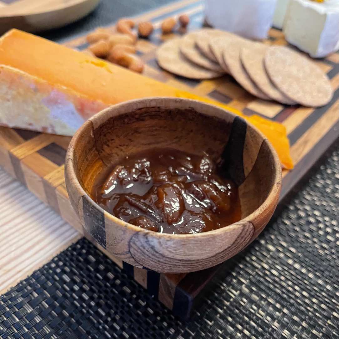 Paguro Upcycle upcycled wooden mini bowl filled with chutney next to cheese and crackers